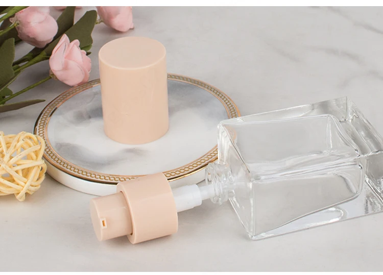 Wholesale cosmetic packaging 30ml square clear empty serum lotion foundation glass bottle with pump factory