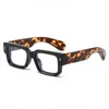 Cornice nera, gambe in tartaruga, pezzo bianco