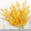 Branche d'orchidée dansante orange à 5 branches
