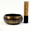 singing bowl and leather stick