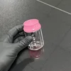 Botella transparente con tapa rosa