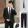 Abito nero-pantaloni neri-camicia bianca-cintura in pelle
