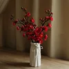 A lady's white vase with 5 red plum blossoms