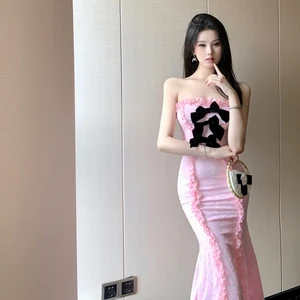 Pink Strapless Mermaid - Style Dress with a Large Black Bow and Ruffled Details Creates a Sweet and Elegant Look Perfect
