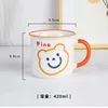 Orange handle with smiley bear face