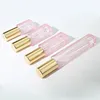 bouteille rose avec pulvérisateur doré