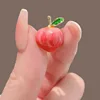 Peach-shaped brooch