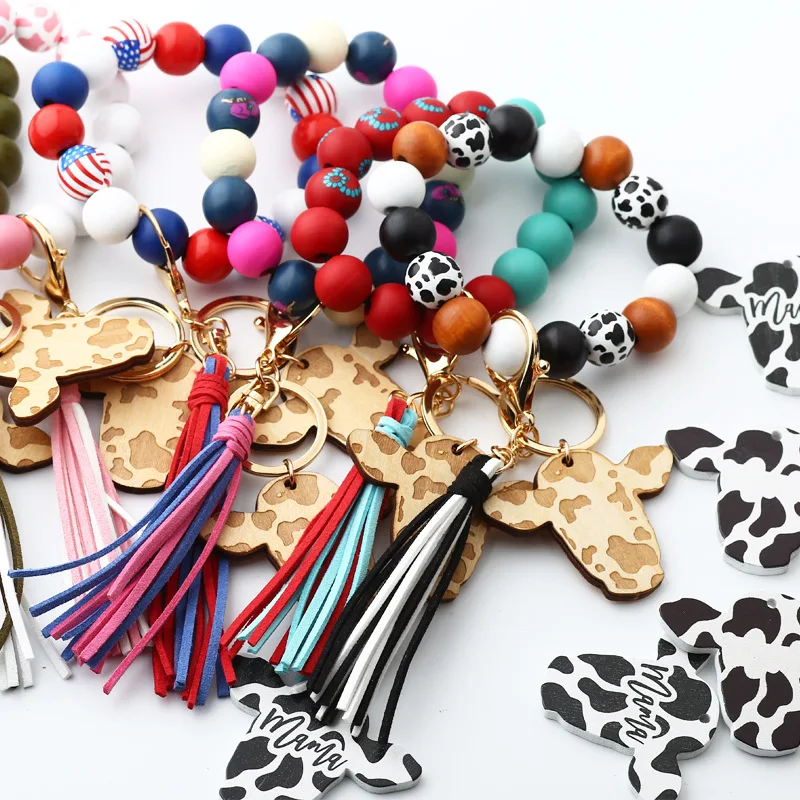 Wholesale Cow Print Leather tassel Cow head wood shavings Charm Tassel  keychain Retro geometric cow shape keyring wristlet From m.