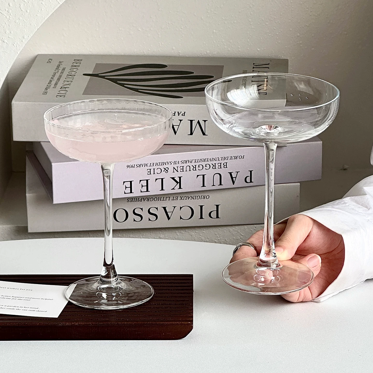 Tall-stemmed cocktail glasses with shallow ribbed bowls