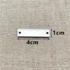 Rectángulo en blanco de 10x40mm con dos agujeros.