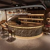 Dark cultural stone + coffee-colored wood grain, long outer arc