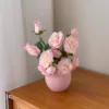 Pink ceramic bottle with pink rose bouquet