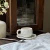 white cup and saucer