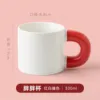 White cup with red handle
