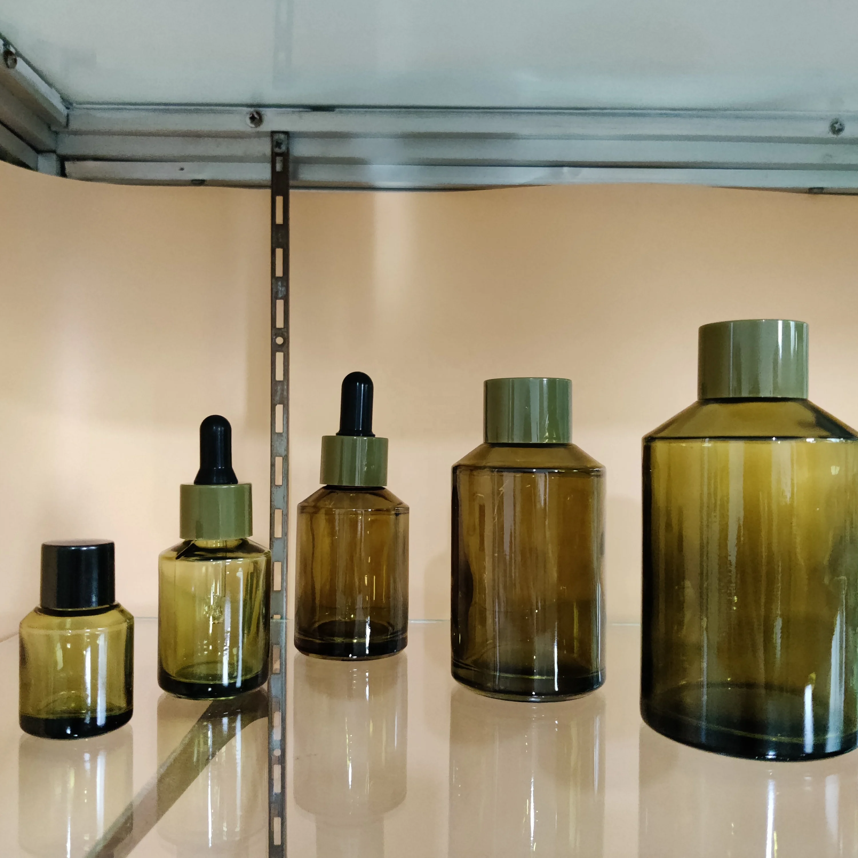 Factory hot sell cosmetic olive green slant shoulder glass lotion bottle with back pump and dropper