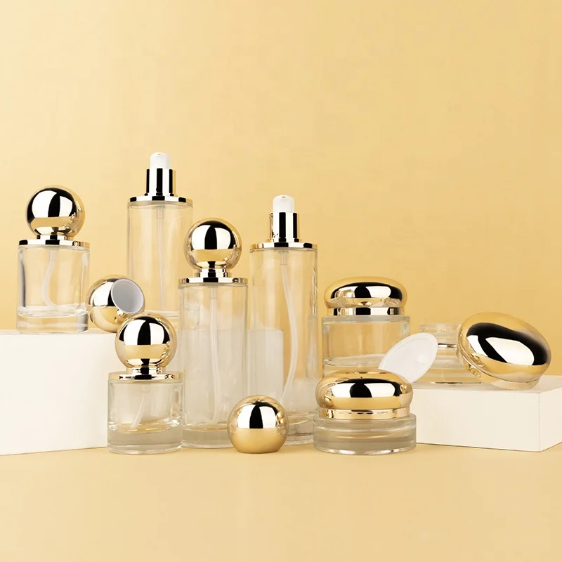 Luxury wholesale skin care packaging gold ball shape unique lotion pump cream jar glass bottle set