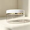 Transparent bottle with white lid and gold line