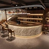 Light-colored cultural stone + coffee-colored wood grain
