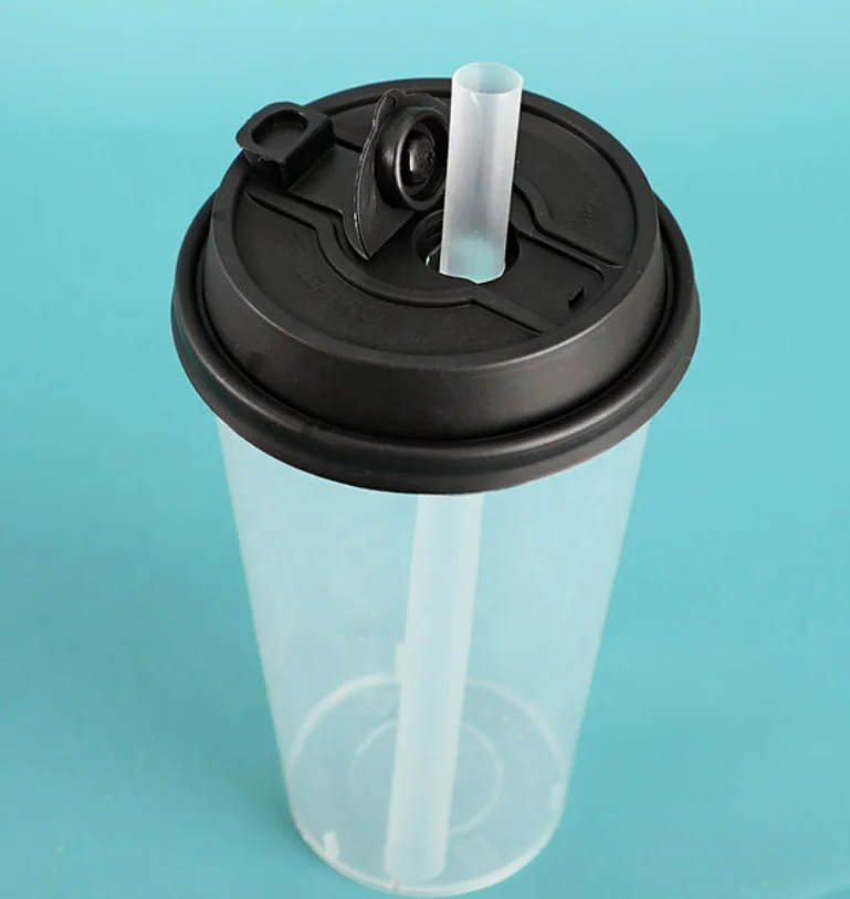 Disposable coffee cup with a lid and a straw in a woman's …