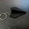 Llavero de avión de papel - negro
