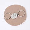 A pair of steel color + steel color keychains