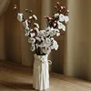 A lady's white vase with 5 white plum blossoms