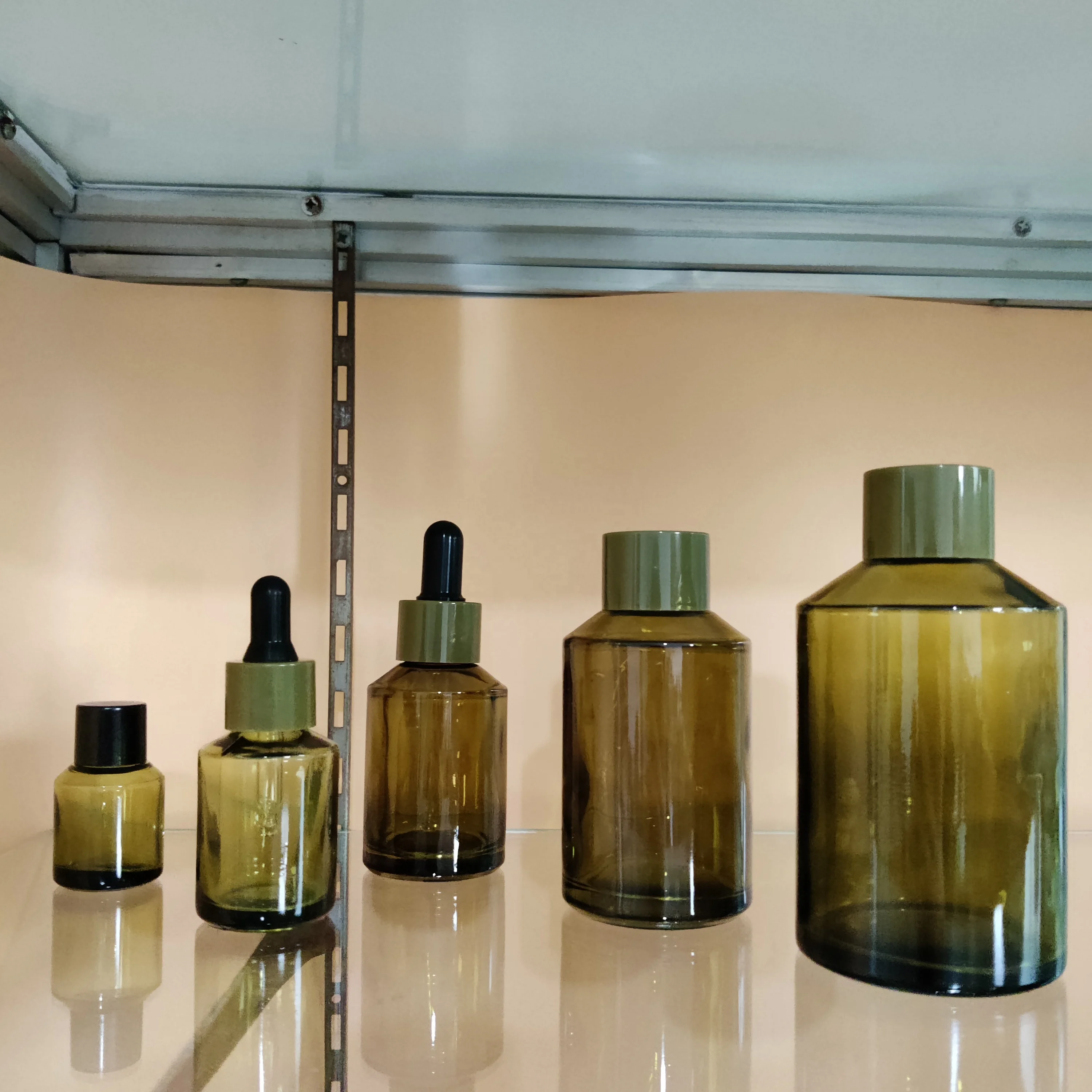Factory hot sell cosmetic olive green slant shoulder glass lotion bottle with back pump and dropper