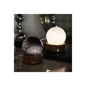 There is a dimmable night light in the bedroom. Use LED light at night. Crystal glass night light with wooden base