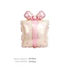 Caja de regalo con lazo de cinta rosa dorada, globos de aluminio