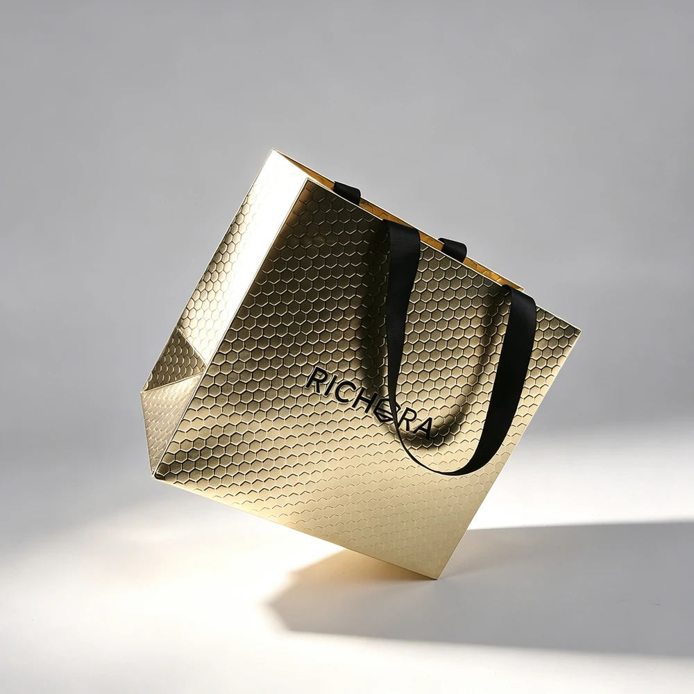 Hot Sale Custom Logo Gold Stamping Coated Paper Ribbon Handle Gift Paper Bag for Cosmetic Gift Packaging