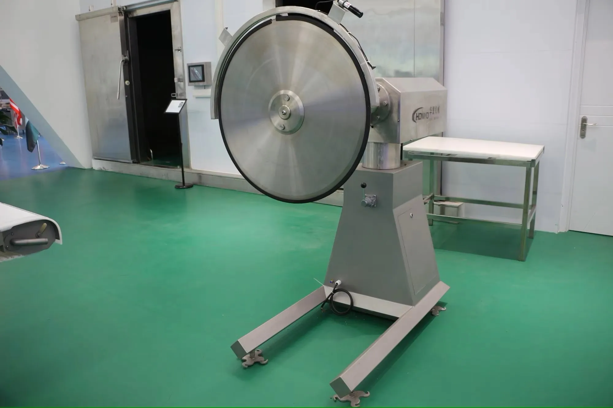 Industrial circular saw machine cutting frozen meat in slaughterhouse and meat factory