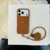 Cordoncino piccolo cavallo dorato in velluto marrone con palla di pelo