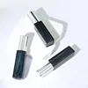 Dark green bottle with silver nozzle cover