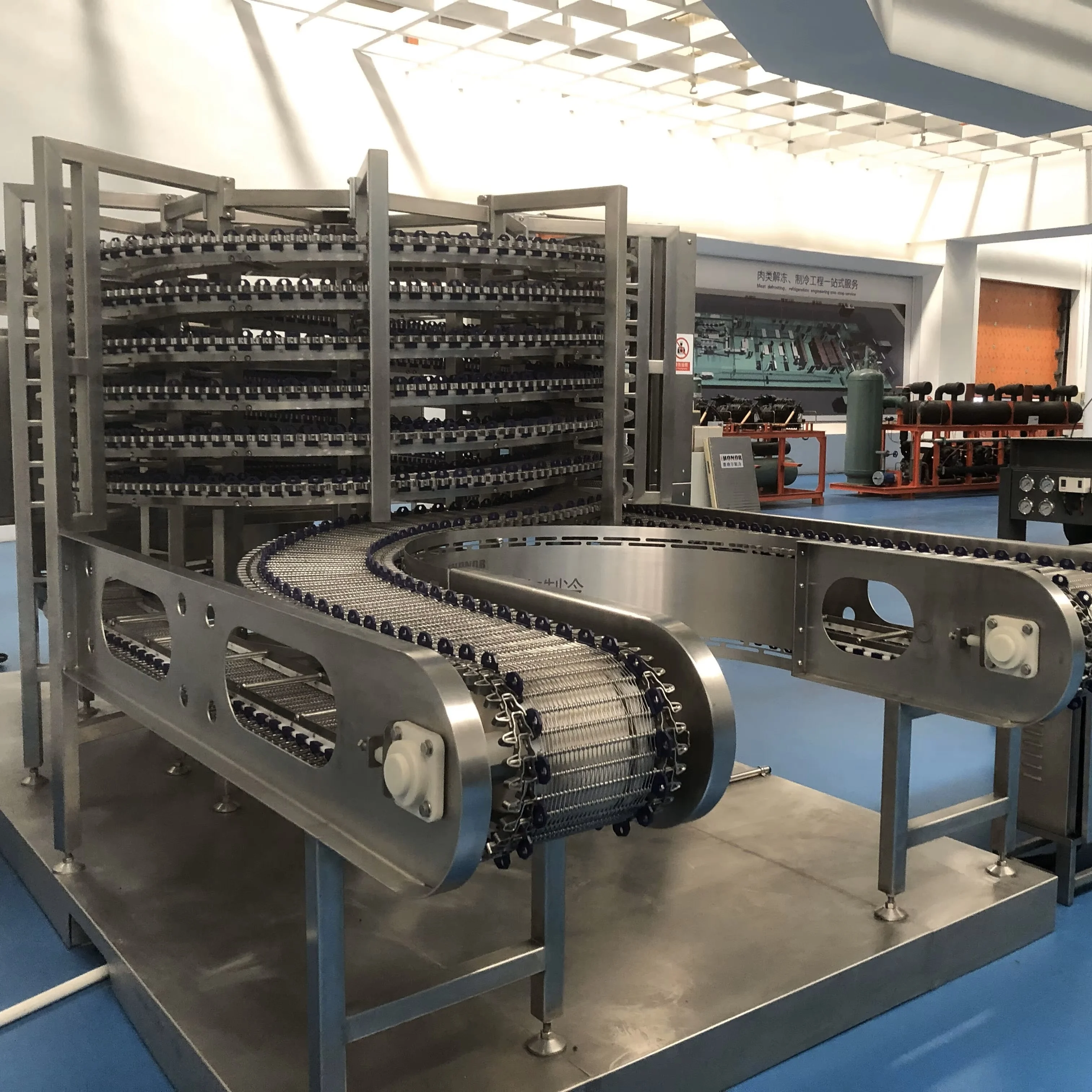 High-efficiency spiral freezers for meat, seafood and prepared food processing lines