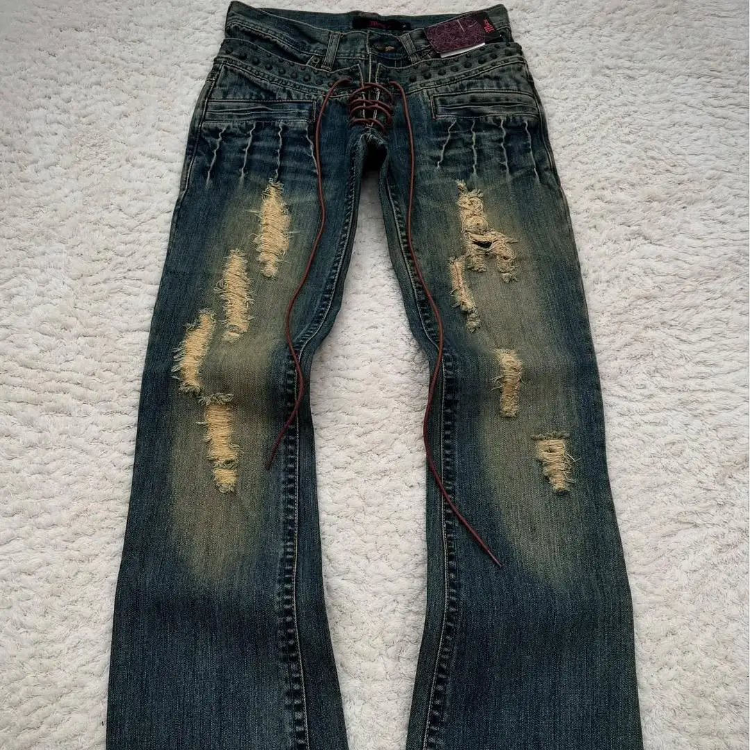 Jeansy vintage z efektem zużycia, z podwójną gumką w pasie, luźne, z przetartym wykończeniem, z zamkiem błyskawicznym i ułożeniem „stakowane”, unisex.