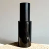 Gloss Black skincare bottle