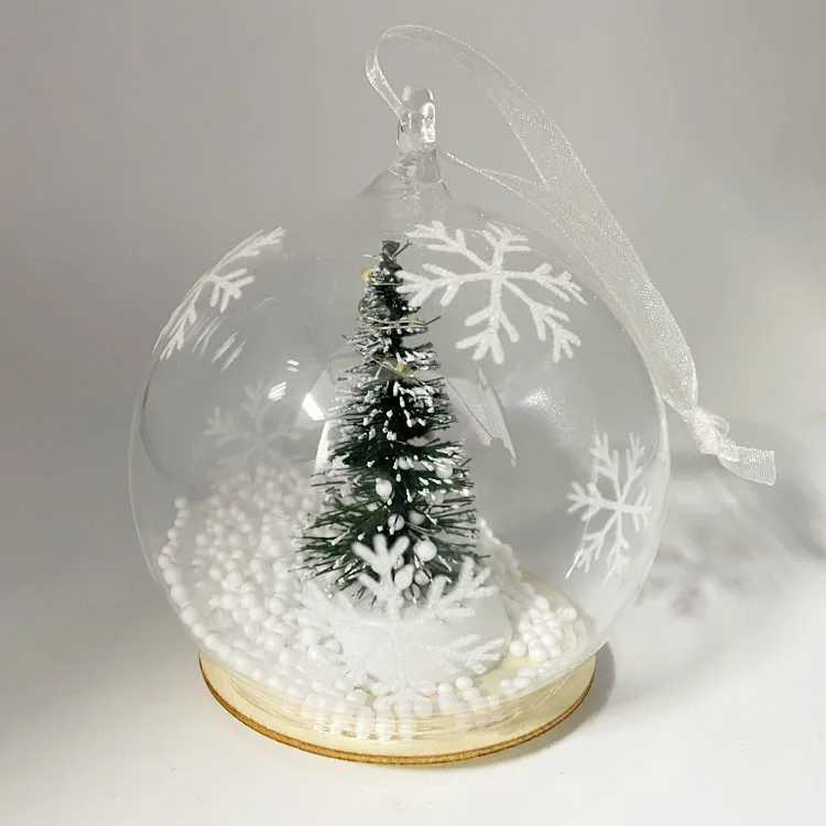 Wholesale led lights up clear hand blown glass hang Christmas ornament craft balls with green plastic tree inside supplier