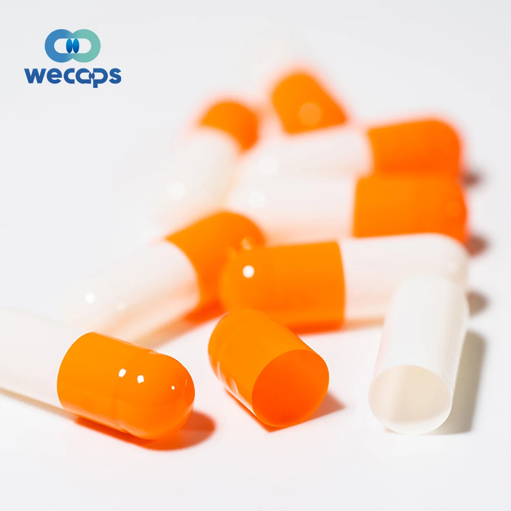 Оранжево белые таблетки в капсулах\. Таблетки в оранжевой капсуле. Капсулы оранжевого цвета. Капсула оранжевая с черным. Капсулы.