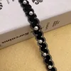 Ruban noir 1,5 cm + perle blanche
