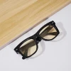 Black framed yellow lens