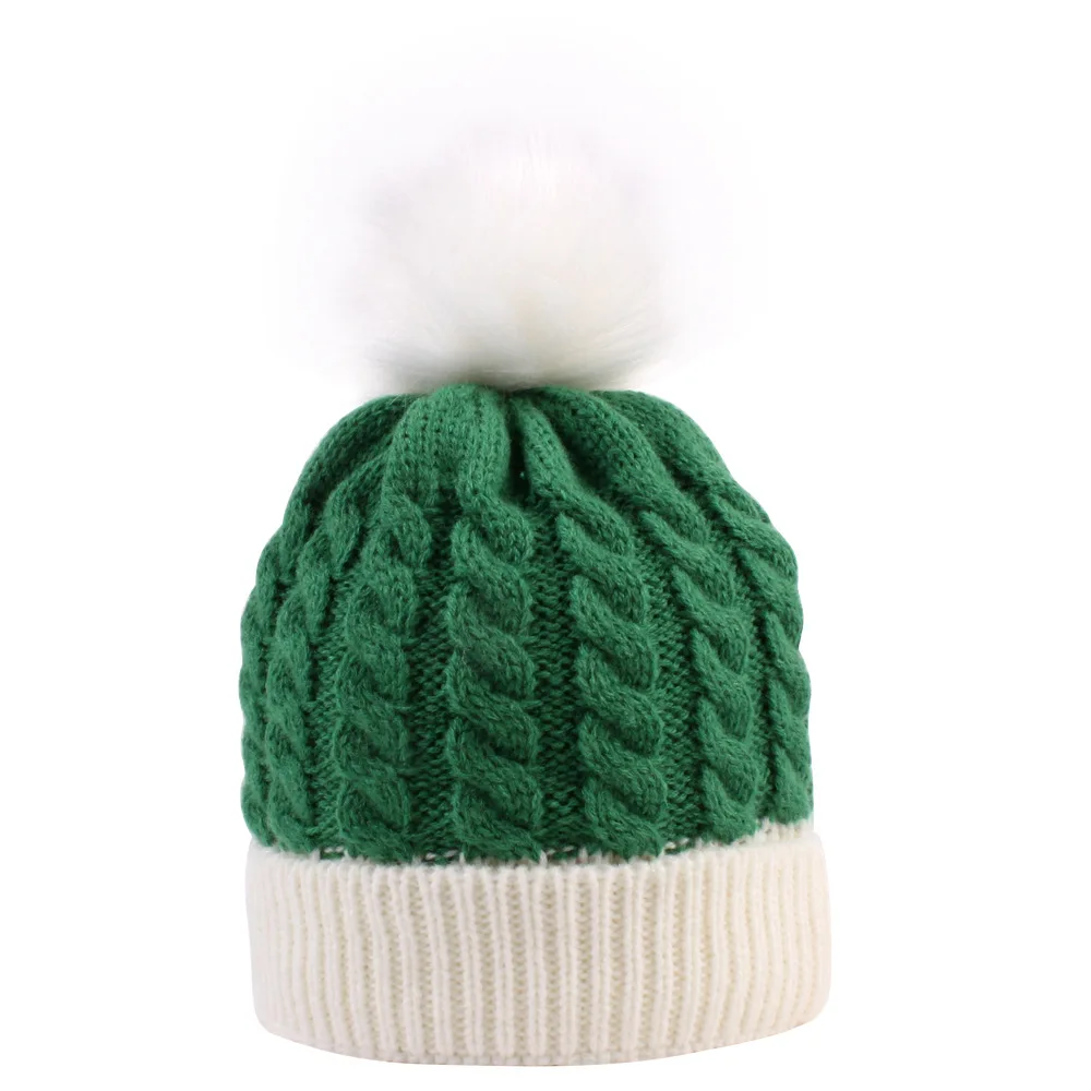 green beanie with pom