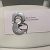 conchiglia bianca bifacciale argento di piccole dimensioni 2 cm