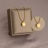 Collana in acciaio al titanio con perline rotonde dorate portafortuna