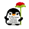 Open-legged penguin holding a rose