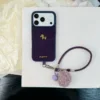 Cordoncino piccolo cavallo dorato in velluto viola con palla di pelo