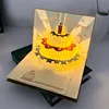 Carte de vœux dorée coulissante avec lumières et musique.