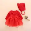 Gonna a trapezio a maniche lunghe con fiocco rosso