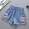 Shorts elasticizzati con fiori arancioni