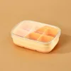 One six-compartment ice cube tray, milky yellow.