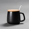 black ceramic mug with lid and spoon